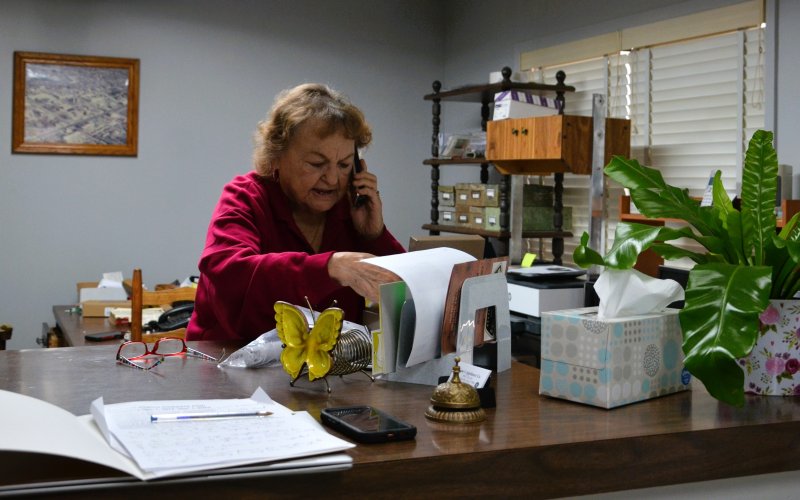 Lucille Drozd answers a customer’s question over the phone Nov. 21. Photo by Hans Lammeman