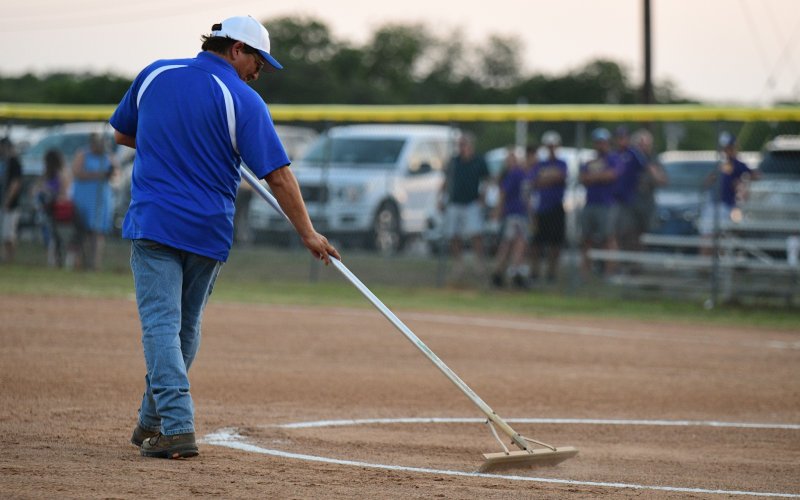 YLL President Raymond Rosas tends to a softball field. File photo by Chuck Grafe.
