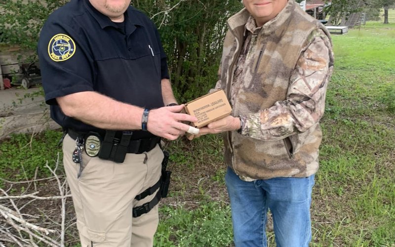 Moulton Police Officer Jeff Alexander accepts the donated service ammunition from local resident Jimmy Bryan, who has offered up his private shooting range to Moulton police for years now whenever they need to update their annual qualifications. Photo by Daniel Beyer