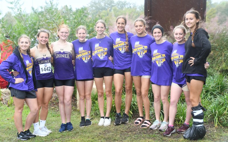 Shiner girls XC team. From left is Megan Winkenwerder (manager), Riley Rainosek, Eve Roberts, Callie Chrismon, Amelia Pohler, Erin Pustka, Brinley Ramirez, Molly Kollaus and Lily Gipson (manager). Photo by Mark Lube.