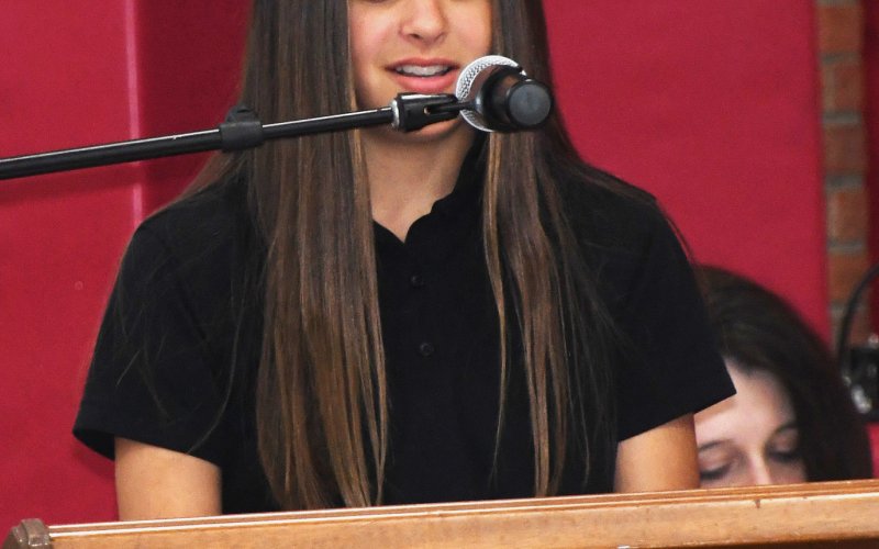 SCS student Eden Rodriguez reads from her essay about veterans.