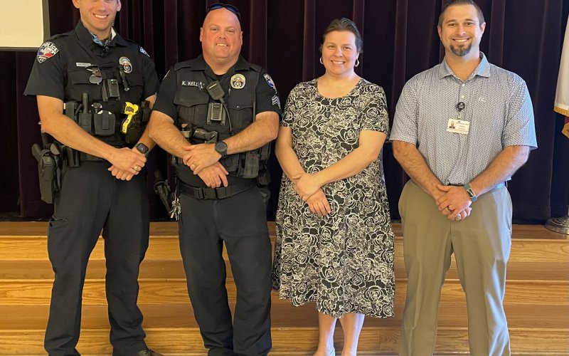Pictured are, left to right, Officer Proske, Sgt. Kevin Kelley, Sarah Fisher and Dr. Kody Selzer.