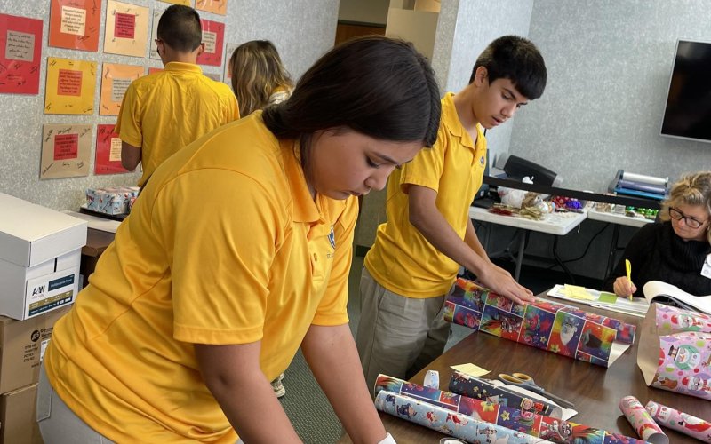St. Joe students focus on wrapping gifts for DLSEC students Thursday, Dec. 1.