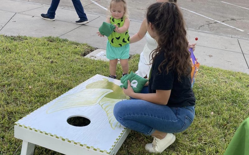A child plays corn hole at the Turtle Wing Foundation’s Monster Dash event in October.