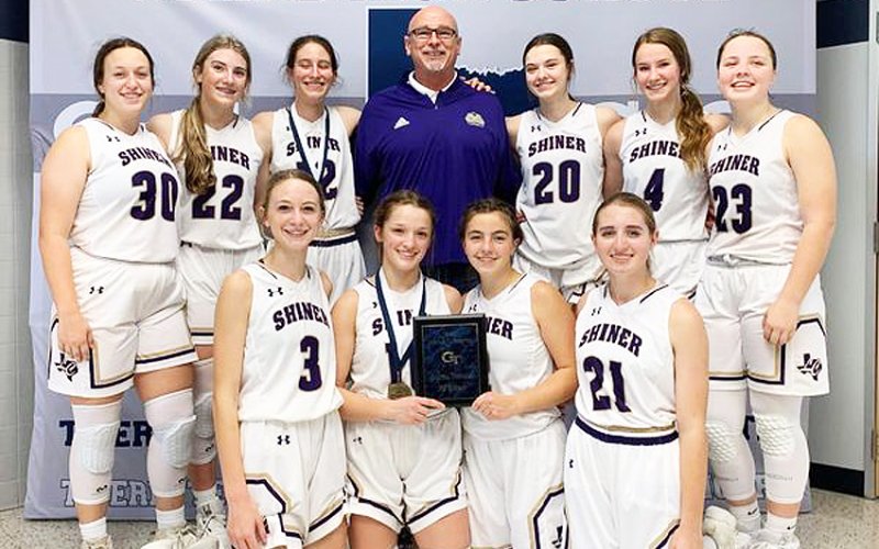 Goliad Tournament winners Shiner Lady Comanches. First row from left is Amelia Pohler, Callie Sevcik, Haley Patek and Megan Winkenwerder.  Top row from left is Alyson Mraz, Addy Siegel, Rylee Vancura, head coach Ray Neal, Morgan Lenehan, Aimee Mitchon and Kailey Boedeker. Photo courtesy of Michelle Winkenwerder.