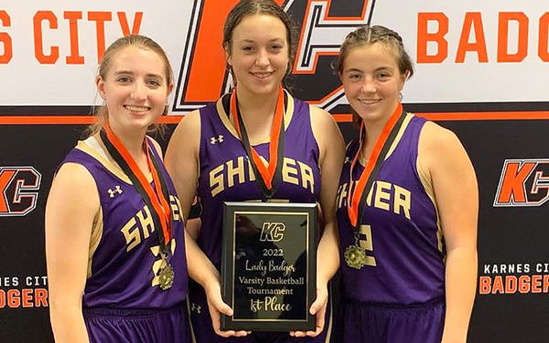 Lady Comanche seniors from left is Megan Winkenwerder, Alyson Mraz and Haley Patek display the KC Tournament trophy. Photo courtesy of Michelle Winkenwerder.