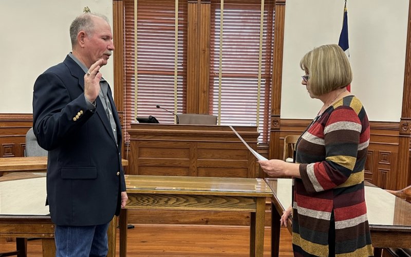 DeWitt County Commissioner Precinct 4 Brian Carson (Left) takes the oath of office administer by County Clerk Natalie Carson in the DeWitt County Courthouse Sunday, Jan. 1. Contributed Photo.