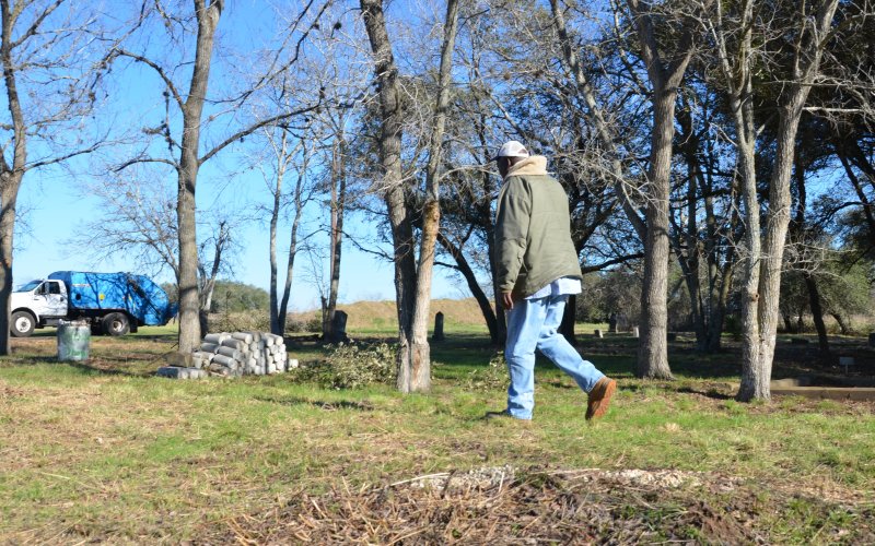 David Mitchell walks back to his work truck after a visit to his great-grandmother’s grave last Wednesday.