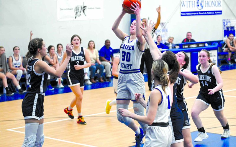 Jules Janak pulls down a rebound in the second quarter of the district game against Bulverde Bracken Christian School here Thursday. Jules had 7 rebounds and 3 steals in the win. Chuck Grafe/Tribune-Herald