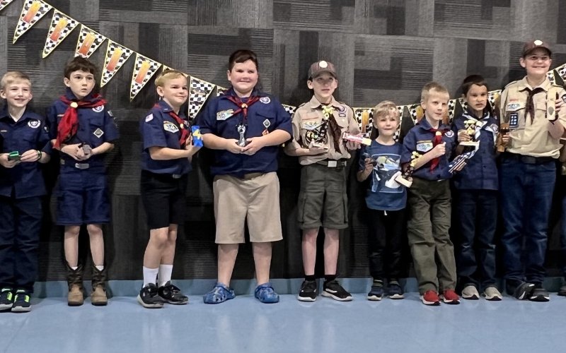 The pinewood derby racers (pictured from left to right) were Clayton Coburn, Clinton Alexander, Joseph Heinhold, Kenward Kolar, Andrew Machacek, William Ulcak, Isaac Bonorden, Nathan Killmer, Eli Bays, Jacob Mahurin, Pierce Wallace, Kolton Wilgus, Ryan Bays, Dawn Bishop, and Caleb Killmer.