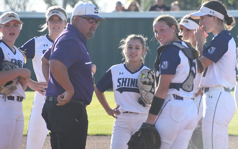 The Lady Comanches talk about strategy with head coach Jason Keller. Shiner beat Schulenburg and edged Ganado in home district action last week. Photo by Mark Lube.