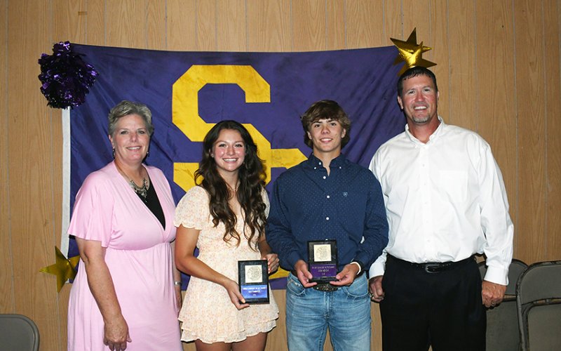 Comanche Hustle Award winners are Riley Rainosek (second from left) and Drew Wenske (second from right) along with Kristi Peterson (left) and Randy Palmer (right). Photo by Mark Lube.