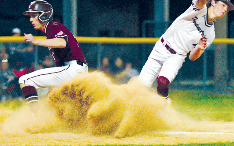 Josh Griffin scores on a wild pitch in the loss to Industrial Friday night.