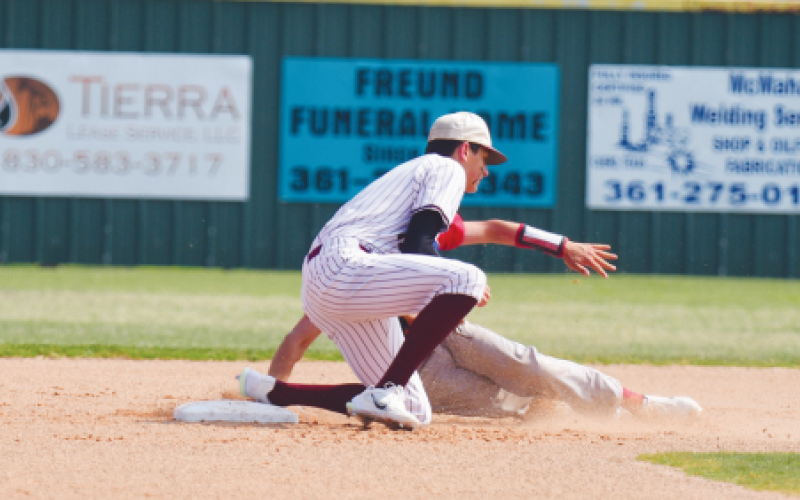 Tanner Wagner tags out the Orlando Flores in the first inning of  Game 1. Chuck Grafe/Tribune-Herald