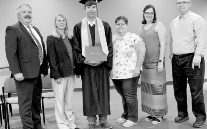 Blake Reed posing for graduation with his family