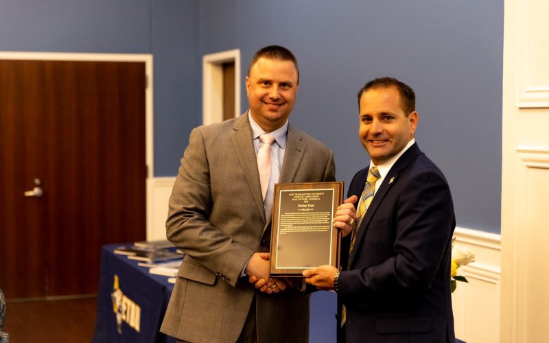 From left is Haas and ETBU Vice President for Student Engagement and Athletics/ Athletic Director, Ryan Erwin, who presented the HOF plaque.