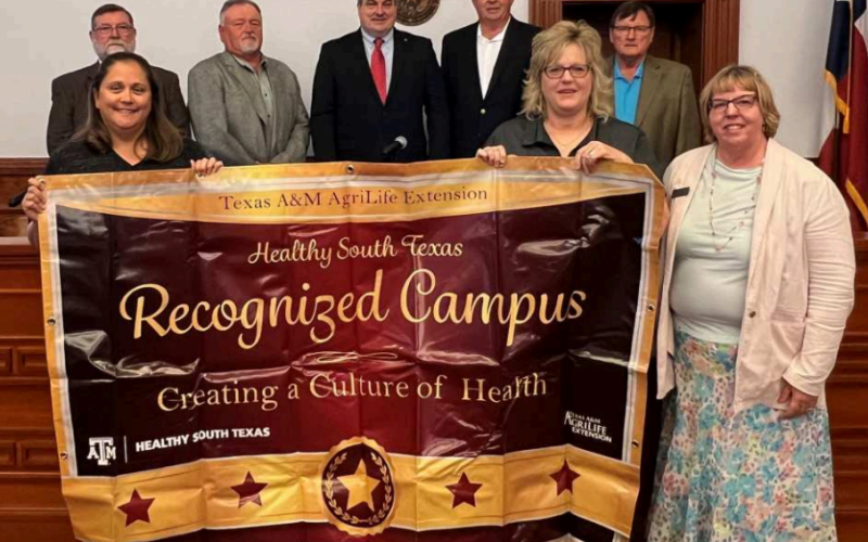 The Moulton Elementary School recently received the designation as a Healthy South Texas Recognized Campus. The campus was commended at Monday’s Commissioners’ Court meeting. The honor was awarded by the Texas AgriLife Extension Service. Holding the banner presented to the school are from left Moulton Elementary third grade teachers, Tiffany Janak and Anita Drabek along with County Extension agent, Natalie Knesek. Back row from left are commissioners Dennis W. Kocian and Kenny Siegel, County Judge, Keith Mu
