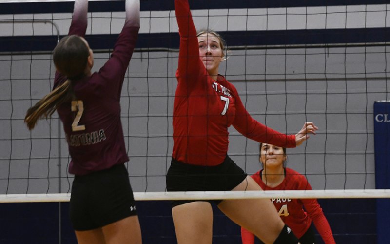 Flatonia tries to block a play at the net by Lady Cardinal Faith Machart (#7). Photo by Mark Lube.