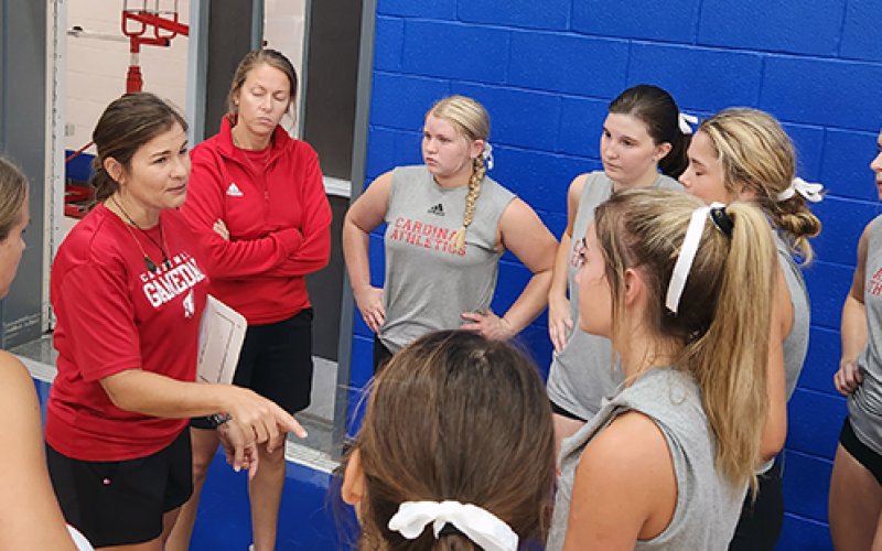 St. Paul  head volleyball coach Nicco Brown (second from left) and assistant coach Karli Rodriguez (third from left) talk things over with the Lady Cardinals Friday in a scrimmage at Yoakum. Photo by Nadine Rex/Yoakum Herald-Times.
