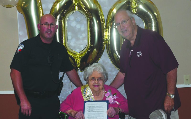 Mrs. Migl received a proclamation from the City of Shiner. She is shown with Officer Mikeska and Mayor Fred Hilscher.