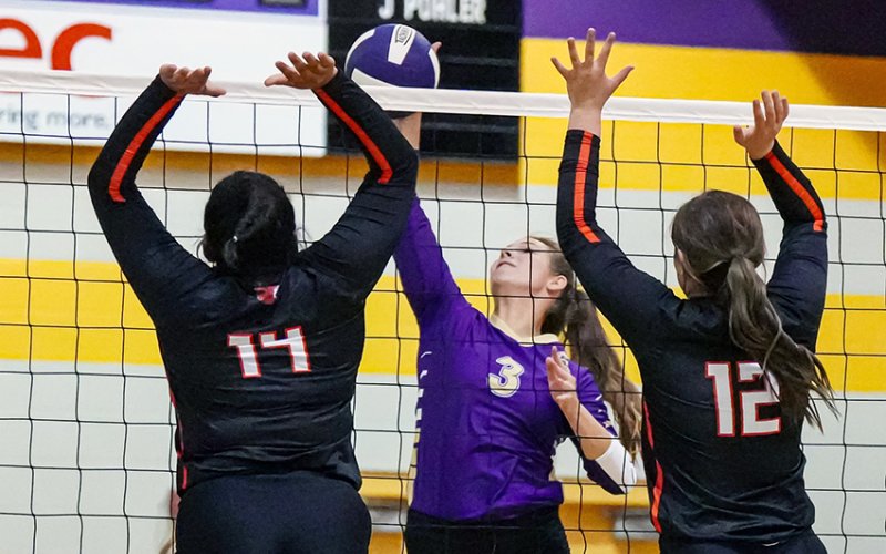 Gonzales players Mallory Clack (14) and Macy Sampe (12) attempt to block a kill attempt by Lady Comanche Chesney Machacek in Friday’s Shiner Tournament. Shiner won the game 2-0.  Photo by Howard Esse.