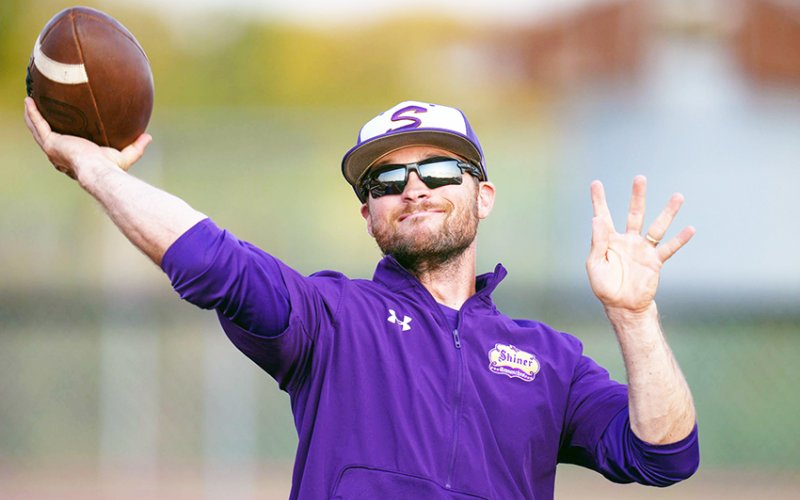 Shiner assistant coach Connor Stefka displays his football throwing ability prior to the start of Shiner’s game at Industrial. Photo by Howard Esse.