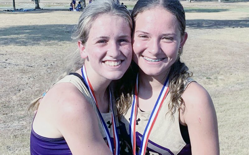 Hayleigh Burns (left) took fourth place individually and Emma Joslin (right) was No. 14 at the Schulenburg meet on Thursday. Photo courtesy of Michelle Winkenwerder.