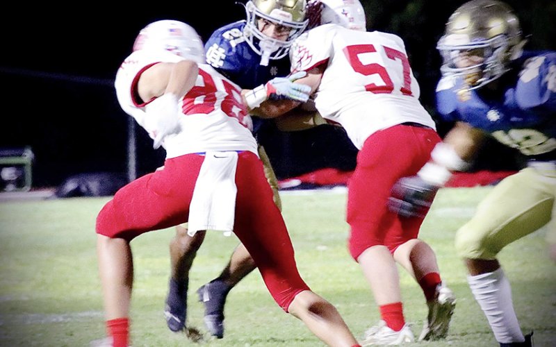 Top photo-A block by Evan Rother (right) springs receiver Jack Ehrig (88) in St. Paul’s away game at SA Holy Cross. Photo courtesy of Brian and Louann Heinsohn