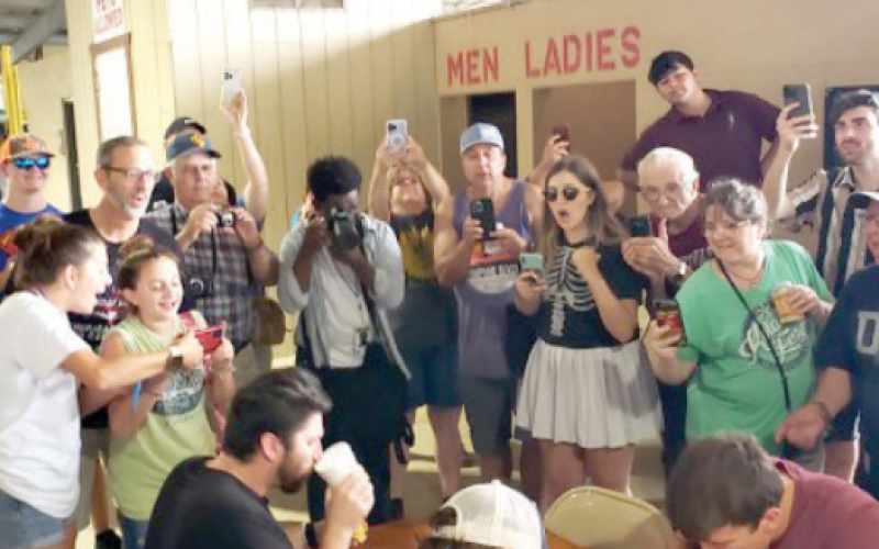 Individuals at Kolache Fest cheer on the kolache eating contest
