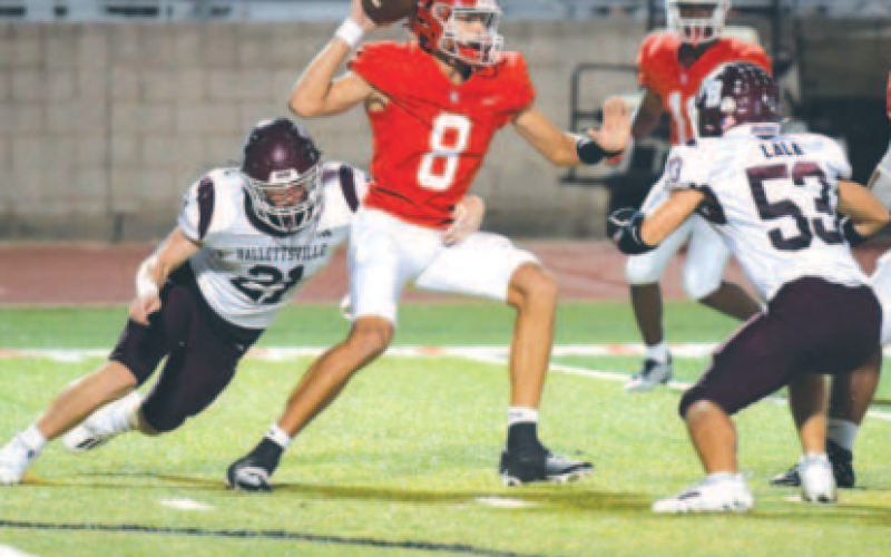 Linebacker Carter Blaha (21) and defensive end Austin Lala pressure Columbus’ Adam Schobel. Dean Kibler/Eyewitness News