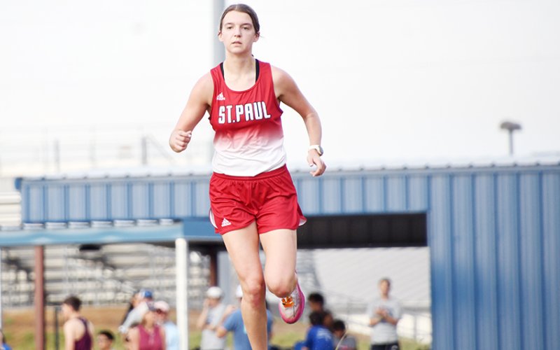 St. Paul senior cross-country athlete Brooke Cerny finished off her high-school tenure with  a bang, finishing first in the TAPPS 2A state race on Monday and leading St. Paul girls to  second-place finish. She is shown here running at Shiner Sept. 16 Shiner Meet. Photo by Mark Lube.
