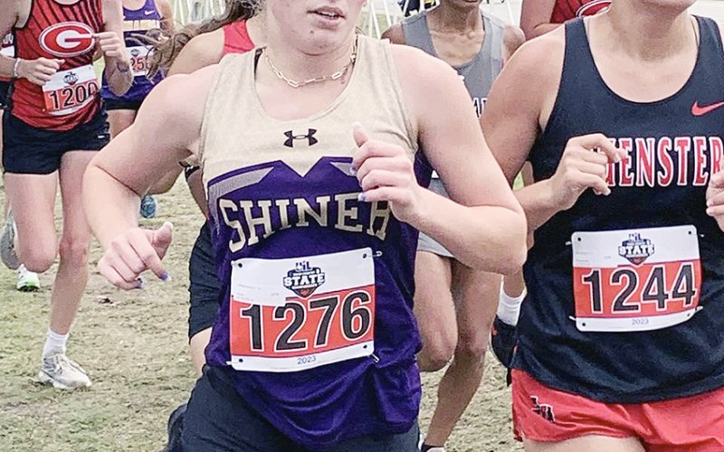 Hayleigh Burns passes Lilly Johnson  from Muenster in the Class 2A girls two-mile race at the state cross-country meet on Saturday. Burns set a state meet PR with a time of 13:26.10. Photo courtesy of Michelle Winkenwerder.