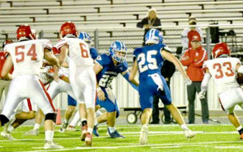 Cameron Cull (25) and Josh Terry (22) eye Tiger halfback Gus Gazon. Chuck Grafe/Tribune-Herald