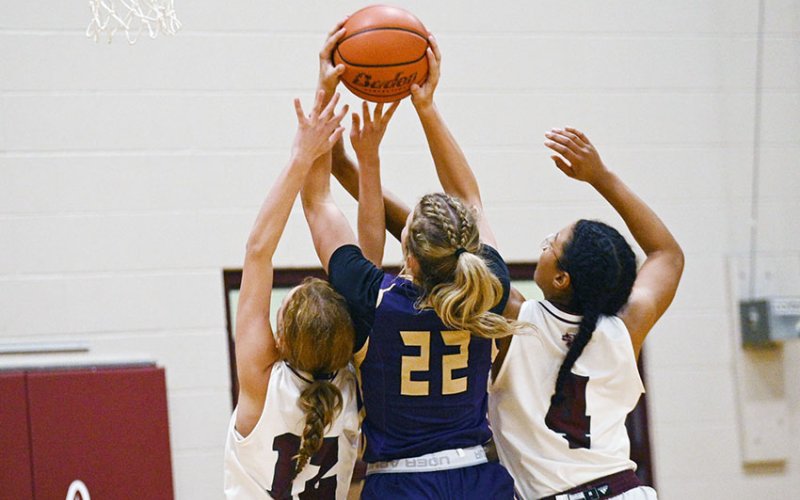 A pair of Lady Brahma defenders try to corral a shot by Shiner’s Addy Siegel Nov. 20 in Hallettsville. Siegel scored six as Shiner won 41-34. Photo courtesy of Chuck Grafe/Hallettsville Tribune-Herald.