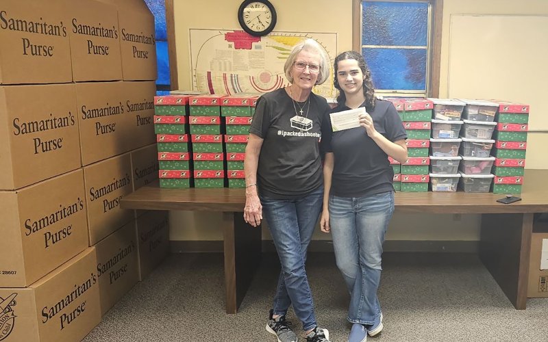 Pictured are Lanelle Amann, left, a member of First Baptist Church who collected the boxes, and Emersen Linn.