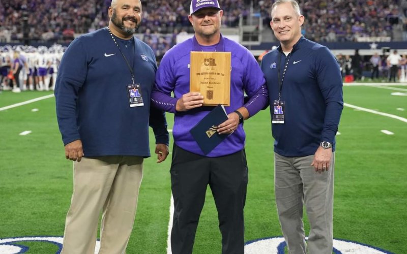 Pictured are Coach Daniel Boedeker, center, with UIL representatives.