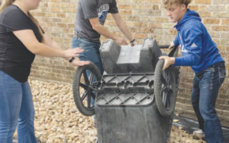 Pictured are Yoakum High School students helping to level rocks on school grounds. Contributed photo.