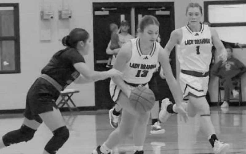 Addison Matula controls the basketball in the district-opening victory here Friday. Chuck Grafe/Tribune-Herald
