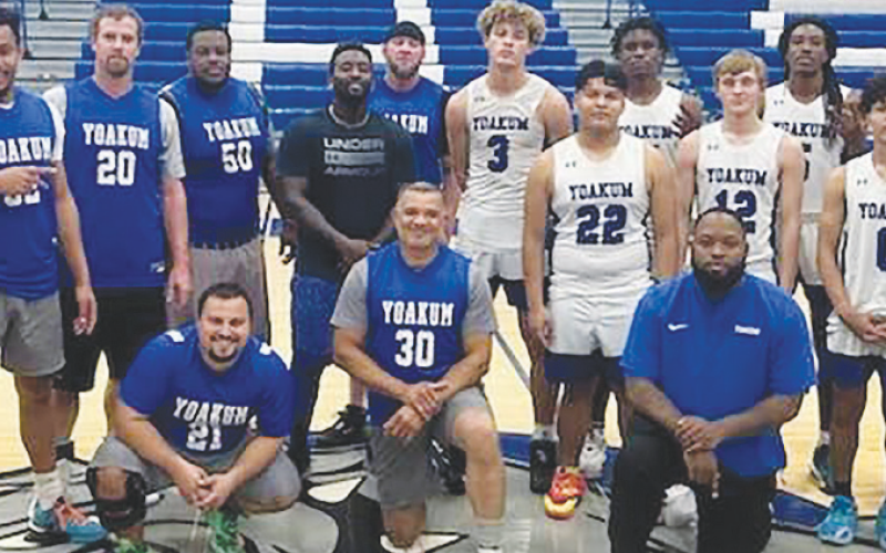 Yoakum High School boys basketball alumni, varsity players, and coaches. The alumni game was won by the varsity team in overtime on Tuesday, Dec. 19 in Yoakum. Contributed photo.