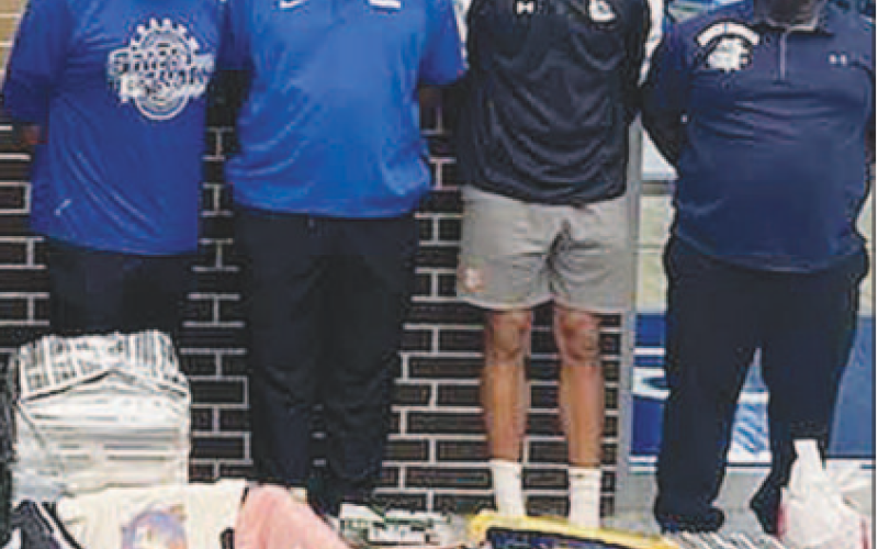 Pictured at left are Yoakum High School boys basketball coaching staff with some of the donations for families in need. Contributed photo.