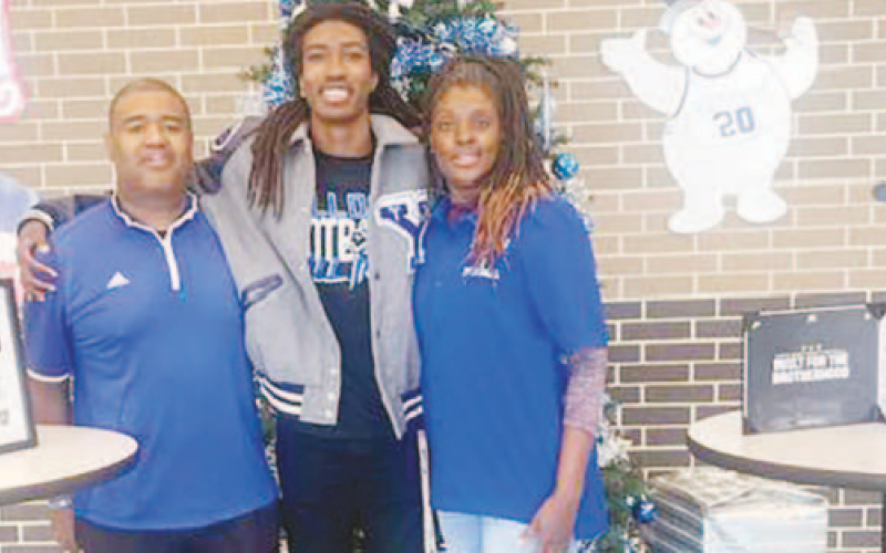 Yoakum High School senior Zachary Taylor recently signed with Army to play football. Pictured from left to right are Zachary’s father Roderick Taylor, Zachary Taylor, and Zachary’s mother Chastity Taylor. Photo by Mark Lube.