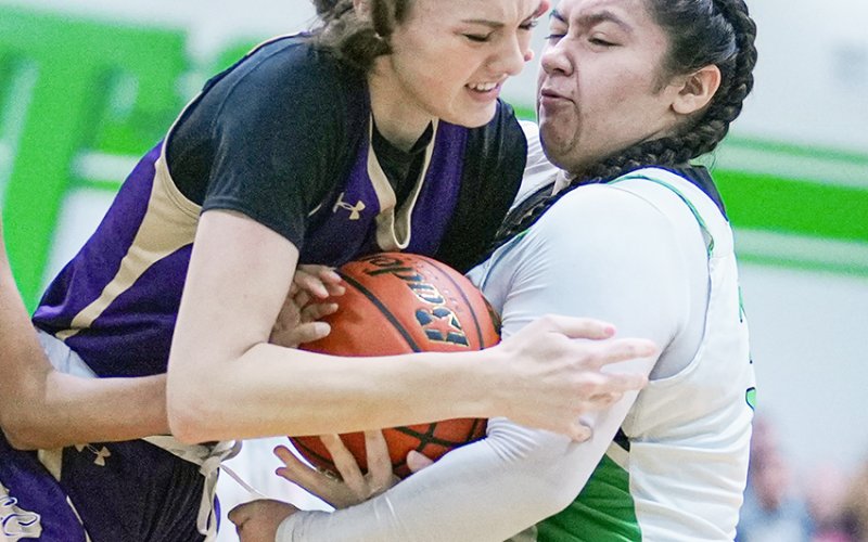 Morgan Lenehan attempts to wrestle possession away from a Bloomington player Jan. 23 in Bloomington. Photo courtesy of Howard Esse.