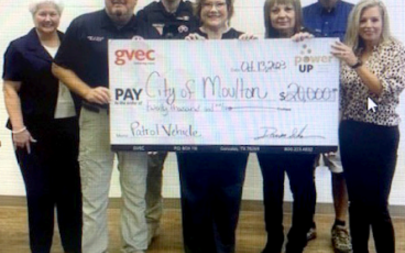 Police Officers accept grant money in the amount of $20,000 from GVEC members