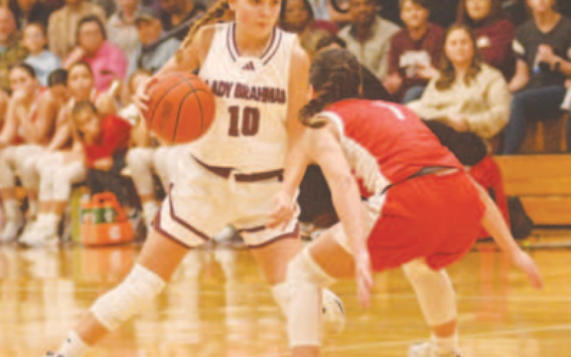 Adalyn Pohl (10) tries to maneuver around Columbus’ Ava Hoffley in the second half of the game here Friday night. Chuck Grafe/Tribune-Herald