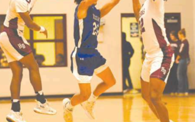 Jashaun Price, left, and Jordan Wilson harass Yoakum's Elyas Garza.