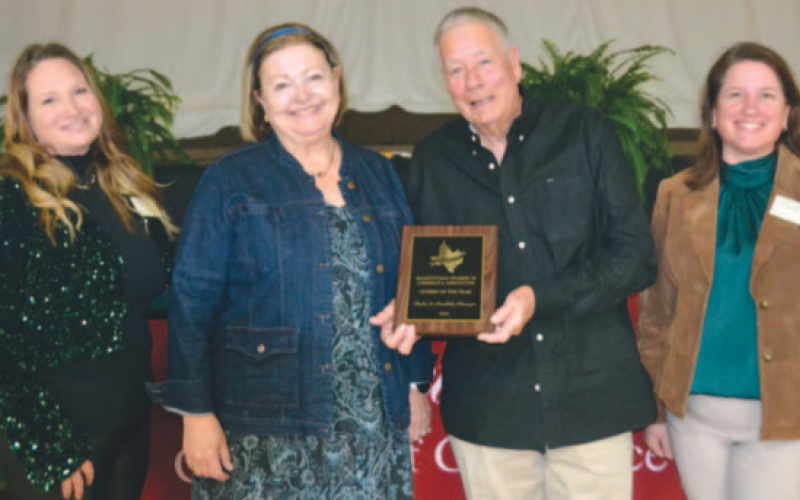 The Neumeyers — Annabeth and Charles — accept their Citizens of the Year Award from Hallettsville Chamber of Commerce and Ahriculture Directors Jennifer Hagan, left, and Christine Brown. Photo by Jimmy Appelt