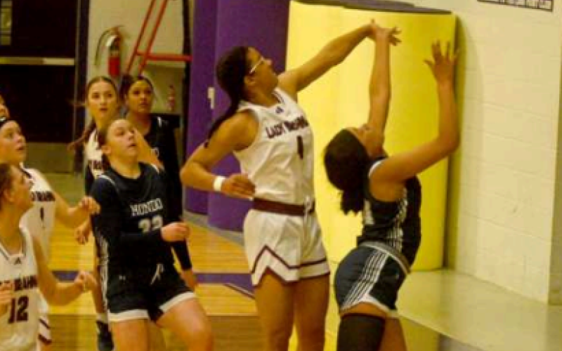 Macy Herring swats away a shot by Hondo’s Grace Edney. Chuck Grafe/Tribune-Herald