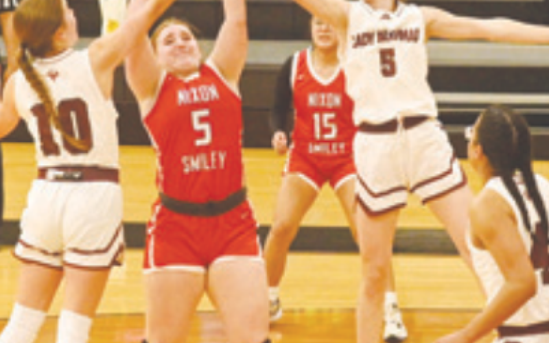 Adalyn Pohl (10) and Kenedy Wood (5) rebound in the Nixon-Smiley victory. Chuck Grafe/Tribune-Herald