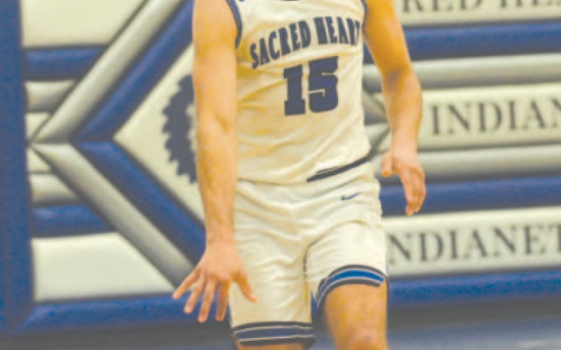 Nic Angerstein brings the ball up court in the Conroe Covenant area round victory here Tuesday, Feb 20. Chuck Grafe/Tribune-Herald