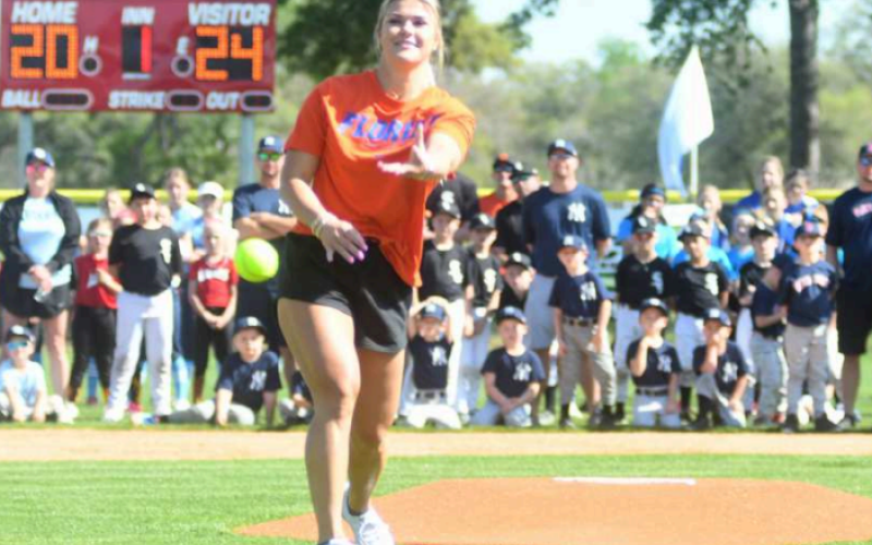 Rylee Trilcek, Hallettsville Alum., former pitcher University of Florida, threw out the first pitch this past Saturday to open up the little league season. photo by Charles Joseph Anthony Grafe